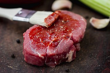 Raw beef steak, greased tomato sauce brush, cooking delicious