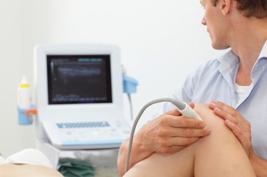 female patient's knee joint dynamic test with ultrasound