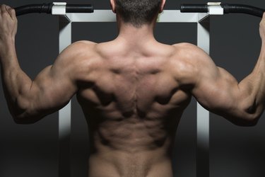 young male bodybuilder doing heavy weight exercise