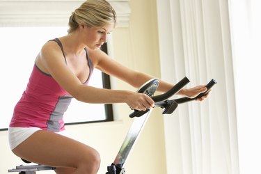 Young Woman On Exercise Bike
