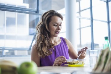 Mid adult woman eating lunch