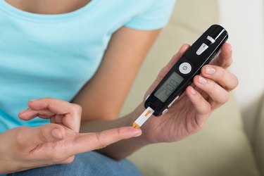 Woman Checking Blood Sugar Level