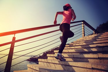 healthy lifestyle asian woman running at stairs seaside