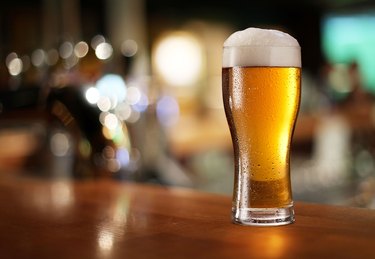 Glass of light beer on a bar counter