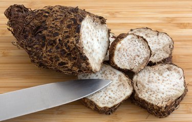Cut Malanga on a wood cutting board with knife