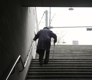 Elderly Man walking up a set of stairs during winter