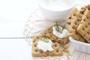 Snack gluten free crackers with cream cheese and dill