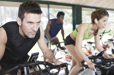 Three Friends Are In A Spinning Class At Gym