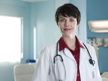 Female doctor in hospital room, portrait