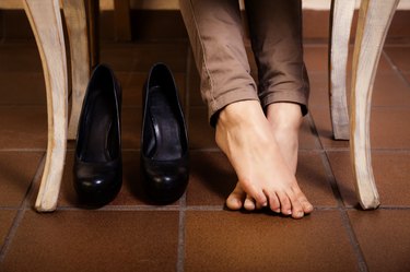 Bare female feet under the vintage table.