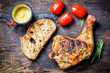 Grilled chicken leg with toast and cherry tomato