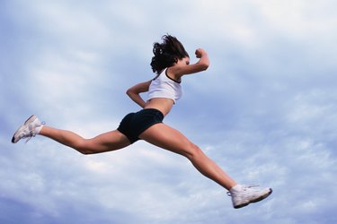 Woman in full stride, jumping