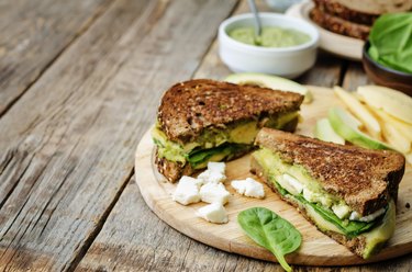 grilled rye sandwiches with cheese, spinach, pesto, avocado and goat cheese