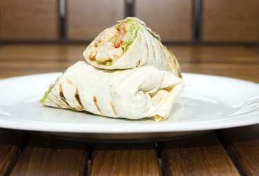 Chicken salad sandwich wrap on a white plate as part of a 3-day diet before surgery