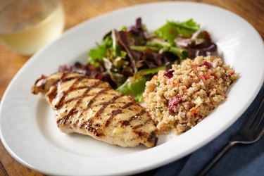 A healthy meal of quinoa, salad and chicken breast.