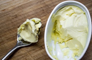 Scooping Butter/Margarine from a Tub High-angle View