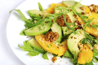 Salad with mango, avocado, arugula and walnuts