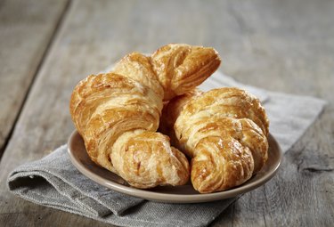 Two croissants on a plate.