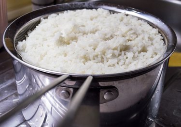 Freshly Cooked White Rice in a Strainer Near a Sink