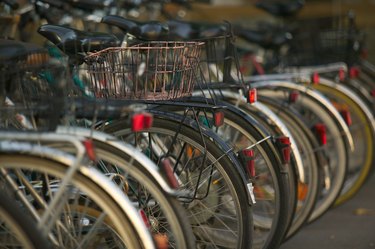 photograph of a row of older style bicycles stacked in bike racks