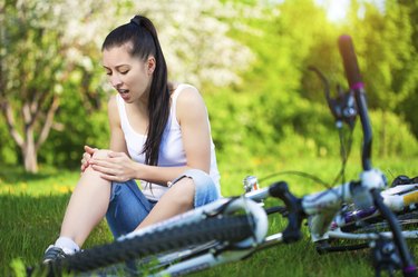 girl fell from the bike in a green park