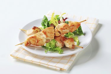 Chicken skewers and salad greens