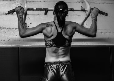Female MMA Fighter doing pull-ups