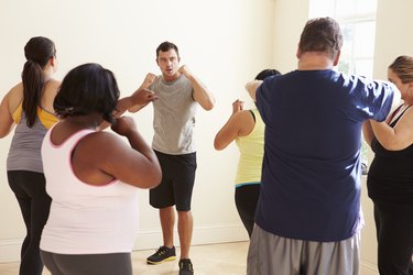 Fitness Instructor In Exercise Class For Overweight People