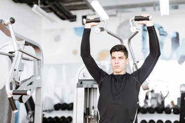 Portrait of a handsome young man training in a gym