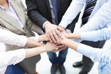 Business people joining hands in circle