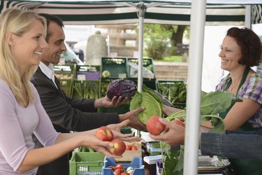 People buying fruit and vegetables at market