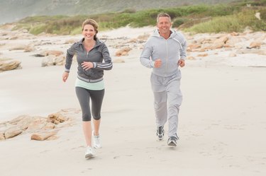 Fit couple jogging to camera