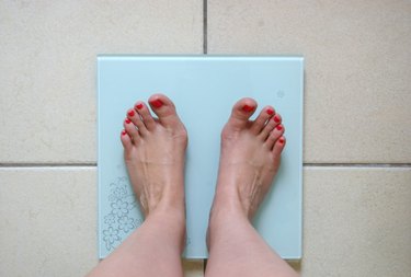 Woman weighing herself
