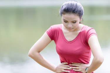 Young beautiful woman is having stomach ache