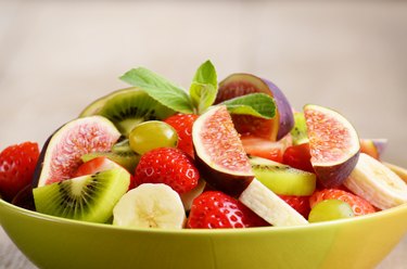 Healthy fruit mix salad on the kitchen table