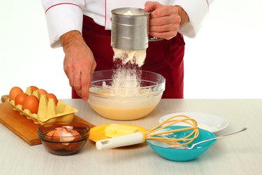 Sifting flour into batter