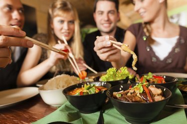 Young people eating in Thai restaurant