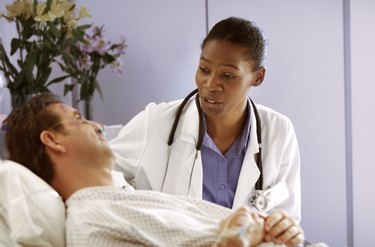 doctor talking to patient in bed