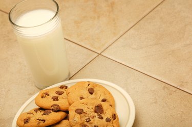 Cookies and glass of milk on work surface