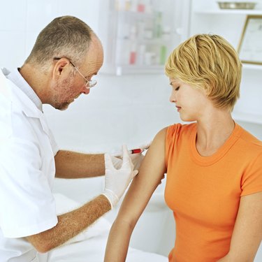 doctor injecting a patient