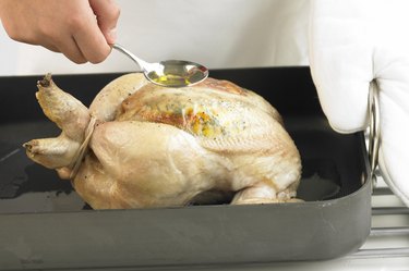 Seasoning a chicken in a roasting pan