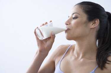 Young woman drinking glass of milk