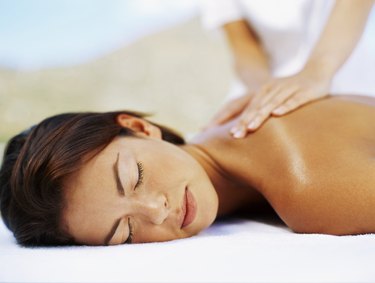 close-up of a young woman getting a back massage from a massage therapist