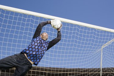 Goalie catching soccer ball