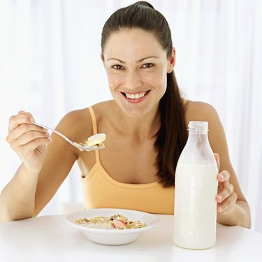 Portrait of a woman eating breakfast cereal with a spoon