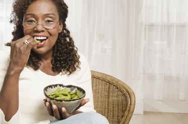 Woman eating edamame