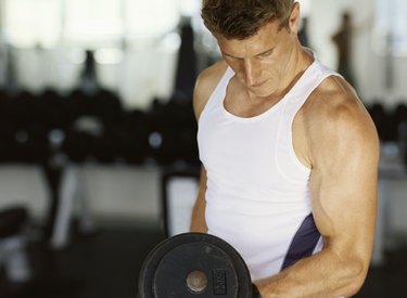 Close-up of a mid adult man exercising with dumbbell