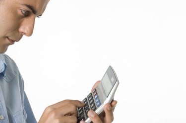 Businessman using calculator