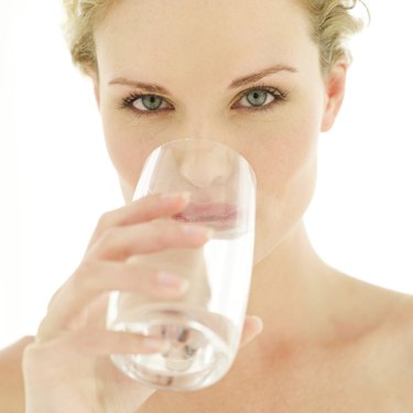 Close-up of a woman drinking water from a glass