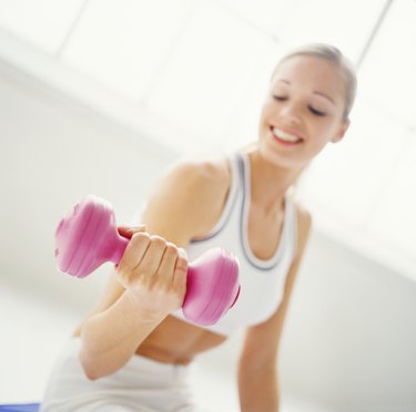 a young woman exercising with dumbbells